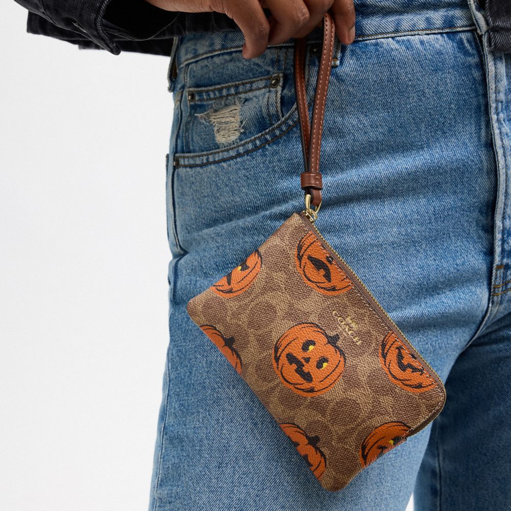 Coach Corner Zip Wristlet In Signature Canvas With Halloween Print Gold Tan Multi