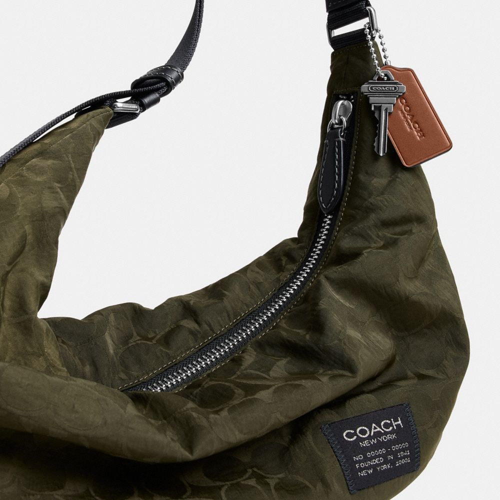 Coach Leon Sling Bag In Signature Nylon Jacquard Dark Moss