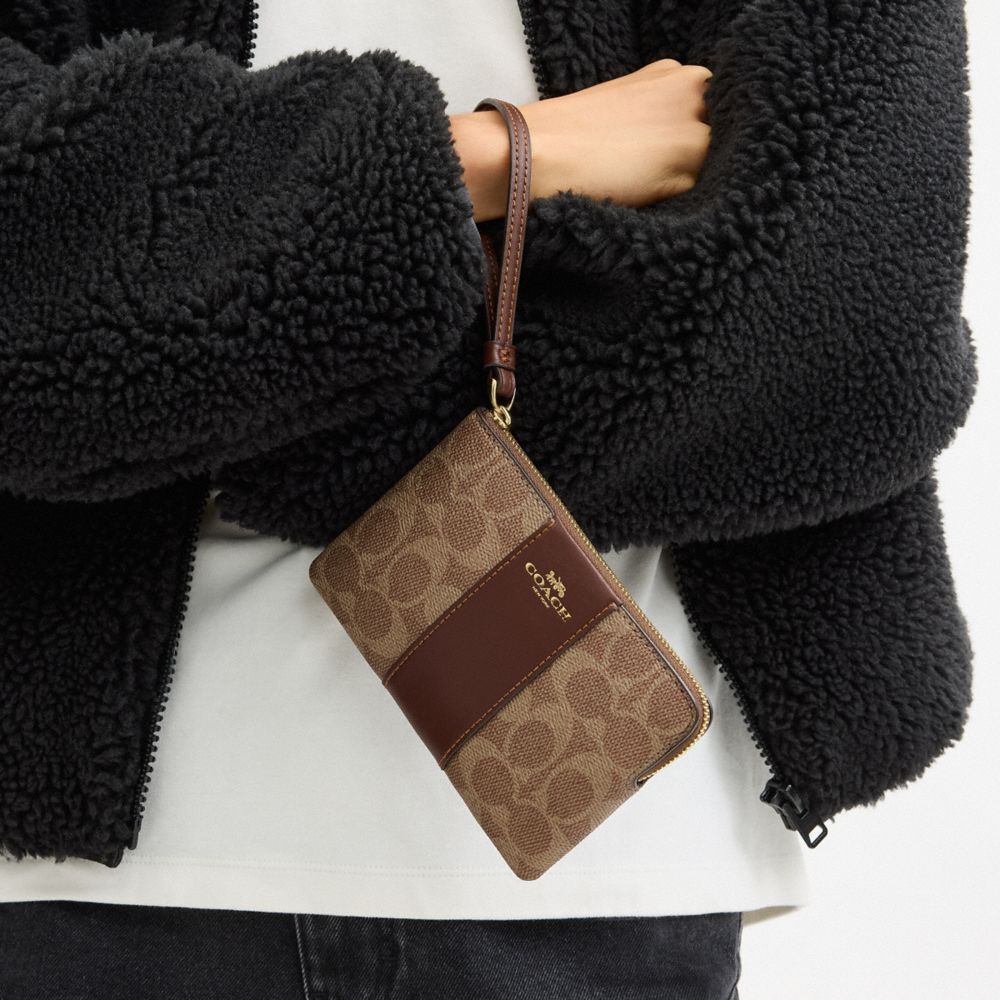 Coach Corner Zip Wristlet In Signature Canvas With Stripe Gold Tan Brown