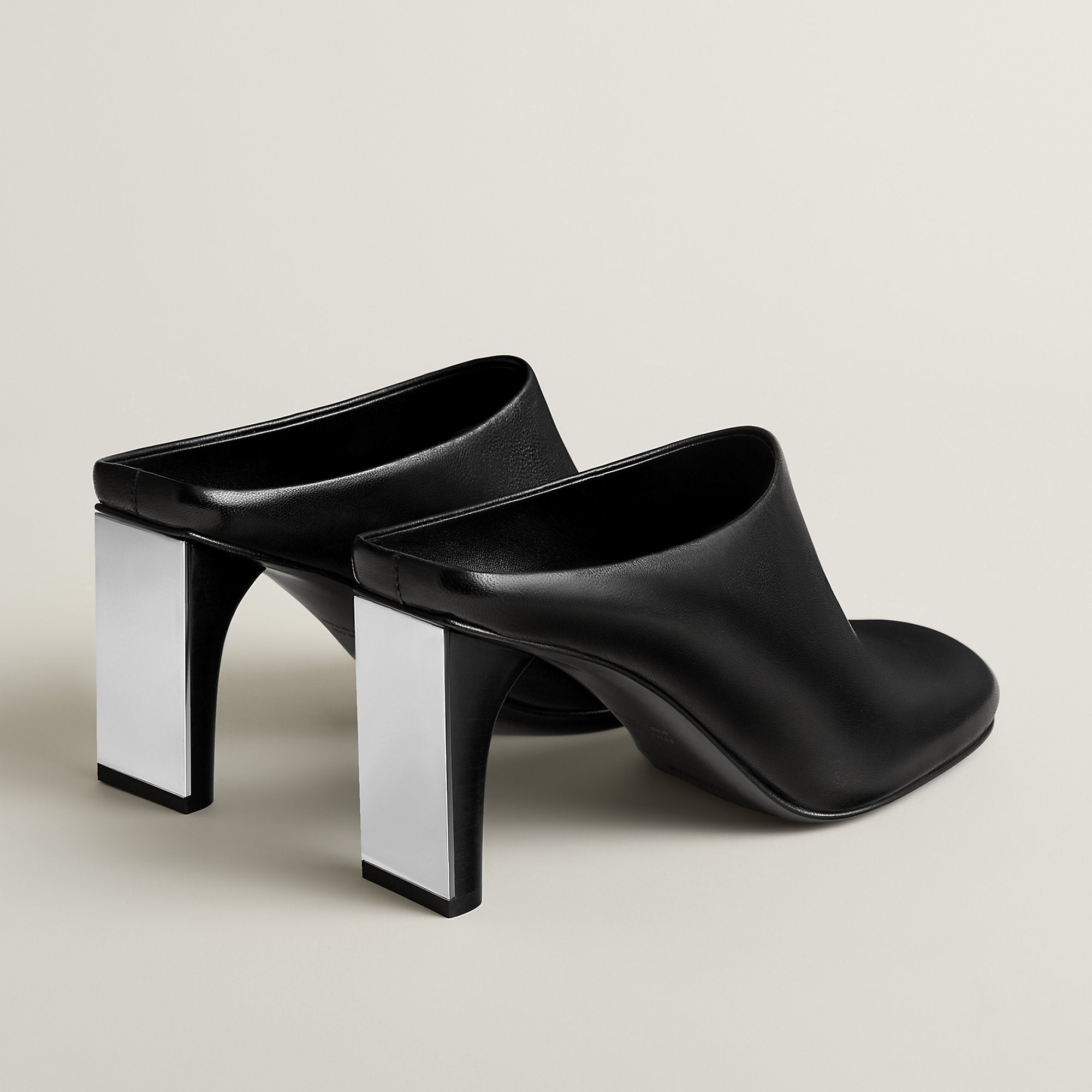 Mule in Nappa leather featuring a graphic mirror heel. For a