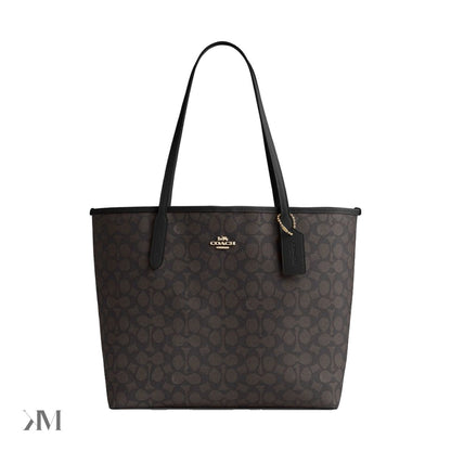 Coach City Tote Bag in Signature Canvas, Gold Walnut Black colourway, showing gold tone hardware and leather trim detail