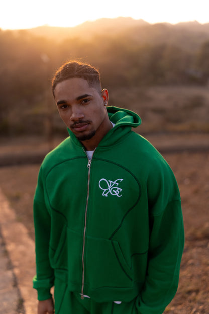 FUE Everyday Essential Sweatshirt Green - male model in green hoodie with FUE logo at sunset
