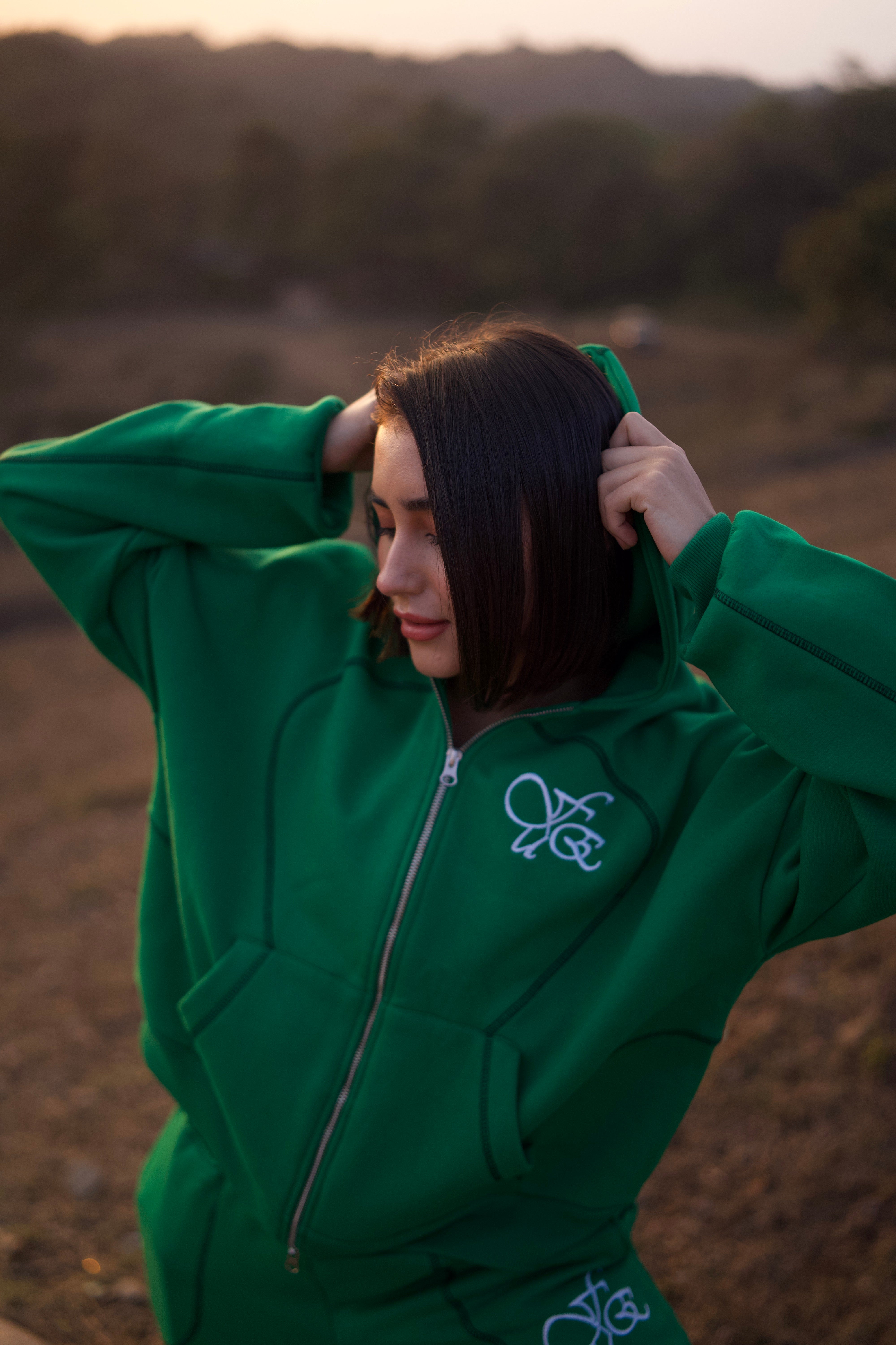FUE Everyday Essential Sweatshirt Green - female model wearing green hoodie in natural outdoor setting