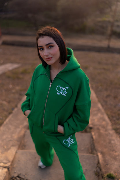 FUE Everyday Essential Sweatpants Green - female model wearing green tracksuit with logo standing outdoors
