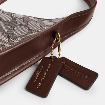 Coach Curve Zip Bag In Signature Jacquard Brass Oak Maple
