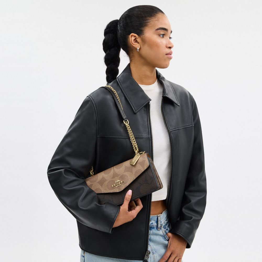 Coach Klare Envelope Crossbody Bag In Blocked Signature Canvas Gold Walnut Tan