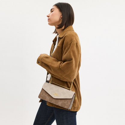 Coach Klare Envelope Crossbody Bag In Blocked Signature Canvas Gold Sand Tan