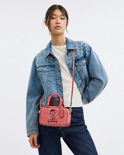 Coach X Peanuts Satchel Crossbody Bag In Signature Canvas With Lucy Signature Canvas-Im-Bright Coral Multi Signature Canvas-Im-Bright Coral Multi