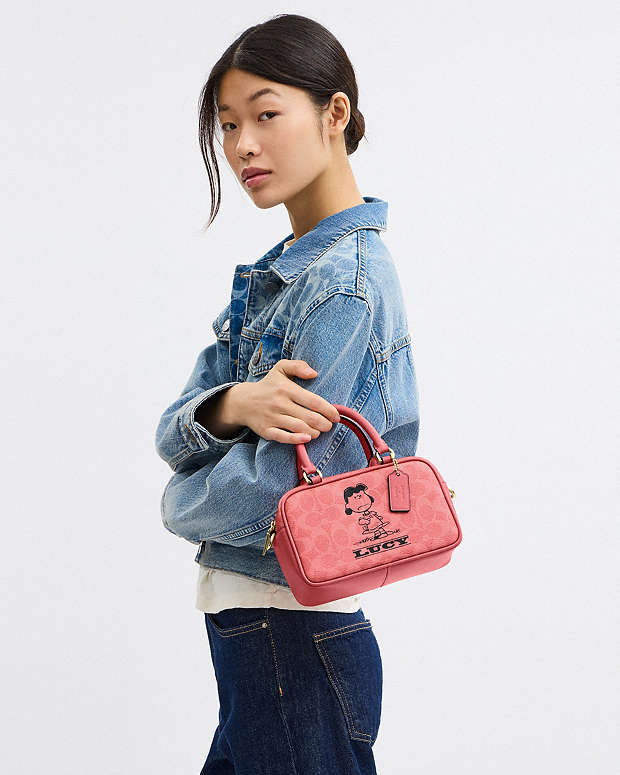 Coach X Peanuts Satchel Crossbody Bag In Signature Canvas With Lucy Signature Canvas-Im-Bright Coral Multi Signature Canvas-Im-Bright Coral Multi