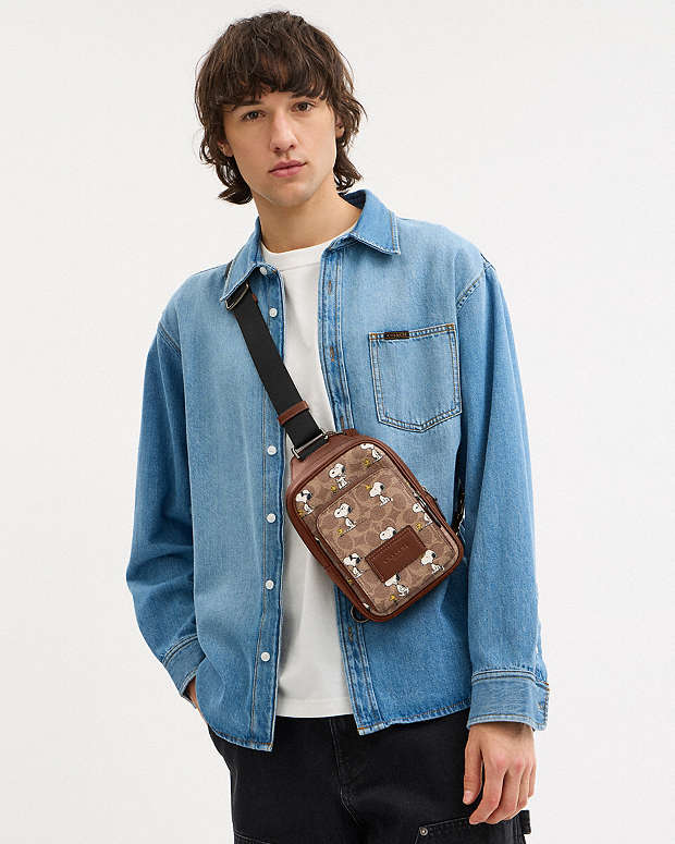 Coach X Peanuts Racer Sling Pack In Signature Canvas With Snoopy Print Signature Canvas-Gunmetal-Tan Multi Signature Canvas-Gunmetal-Tan Multi