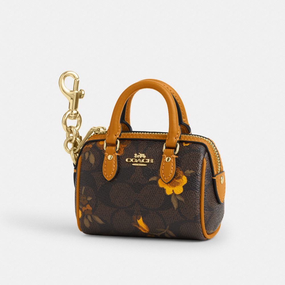 Coach Mini Rowan Bag Charm In Signature Canvas With Floral Print Im Walnut Yellow