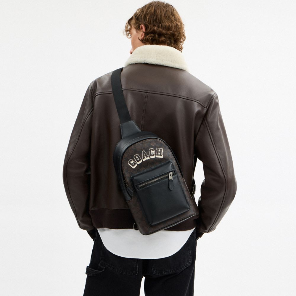 Coach West Pack In Signature Canvas With Varsity Graphic Qb Walnut Multi