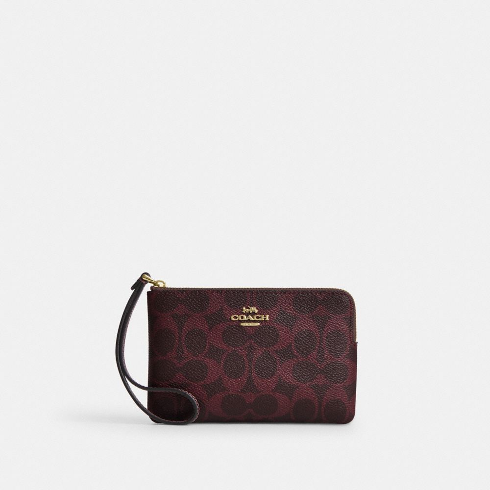 Coach Corner Zip Wristlet In Signature Canvas Gold/Black Currant