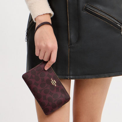 Coach Corner Zip Wristlet In Signature Canvas Gold/Black Currant