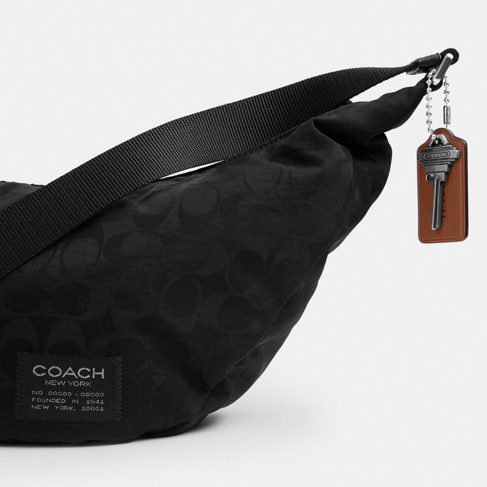 Coach Leon Sling Bag In Signature Nylon Jacquard Black
