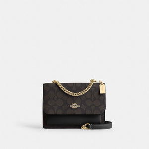 Coach Mini Klare Crossbody Bag in Signature Canvas Gold Walnut Black, front view showing gold-tone hardware and magnetic snap closure