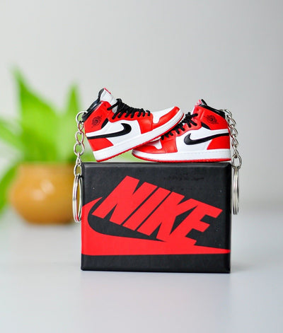 A pair of keychains in a mini sneaker box